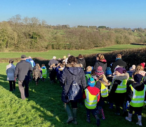 Bishop Jan McFarlane leads the procession around the boundaries of the new part of the cemetery